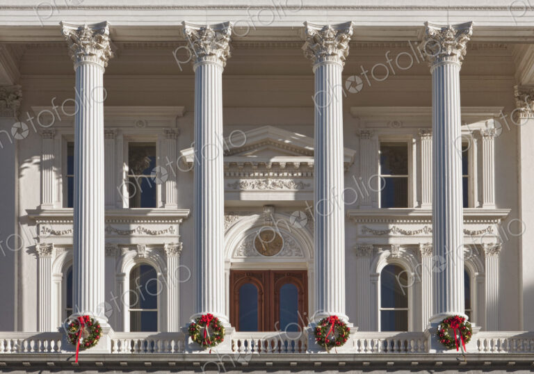 The neoclassical California State Capitol Building at Christmas time, wreaths on each…