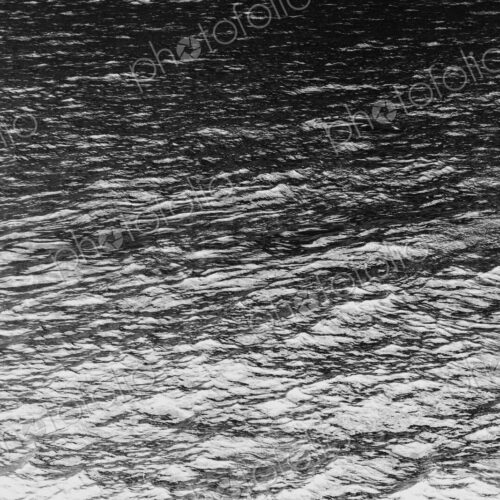The ocean, water and waves, view of the water surface, in black and white. The ocean, water and waves, view of the water surface, in black and white.