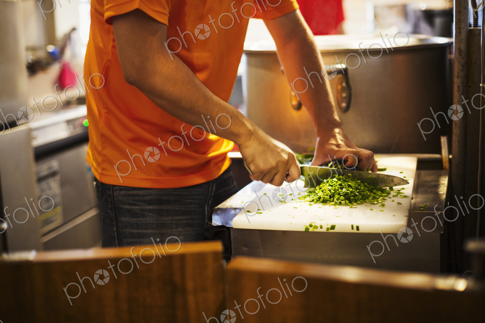 The ramen noodle shop. A chef chopping vegetables.