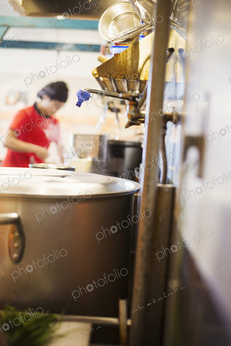 The ramen noodle shop. A chef working in a kitchen.