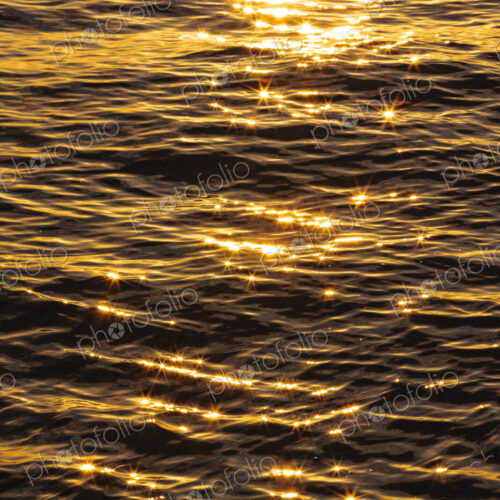 The reflections of sunshine on the surface of moving water. The reflections of sunshine on the surface of moving water.