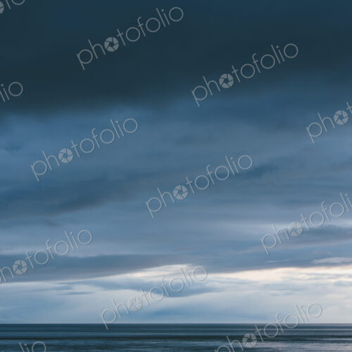 The sea and sky over Puget Sound in Washington, USA. The horizon with light and cloud…