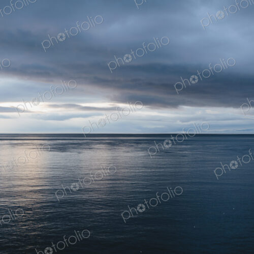 The sea and sky over Puget Sound in Washington, USA. The horizon with light cloud…