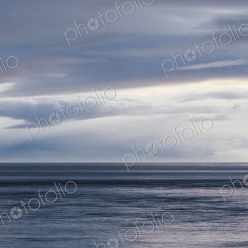 The sea and sky over Puget Sound in Washington, USA. The horizon with light cloud…