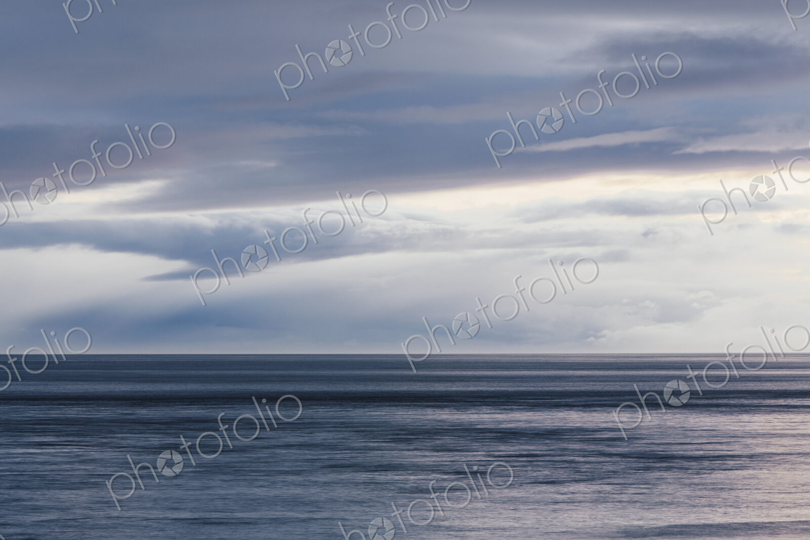 The sea and sky over Puget Sound in Washington, USA. The horizon with light cloud…