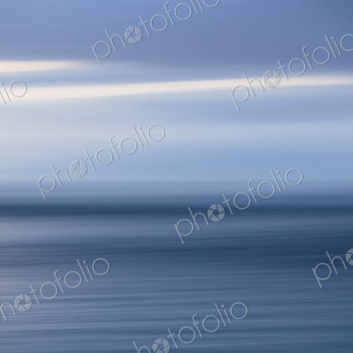 The sea and sky over Puget Sound in Washington, USA. The horizon with light cloud…