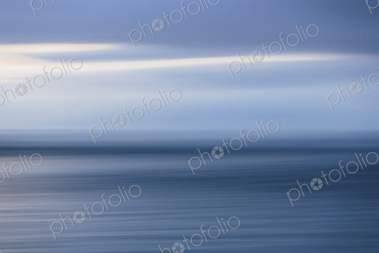 The sea and sky over Puget Sound in Washington, USA. The horizon with light cloud…