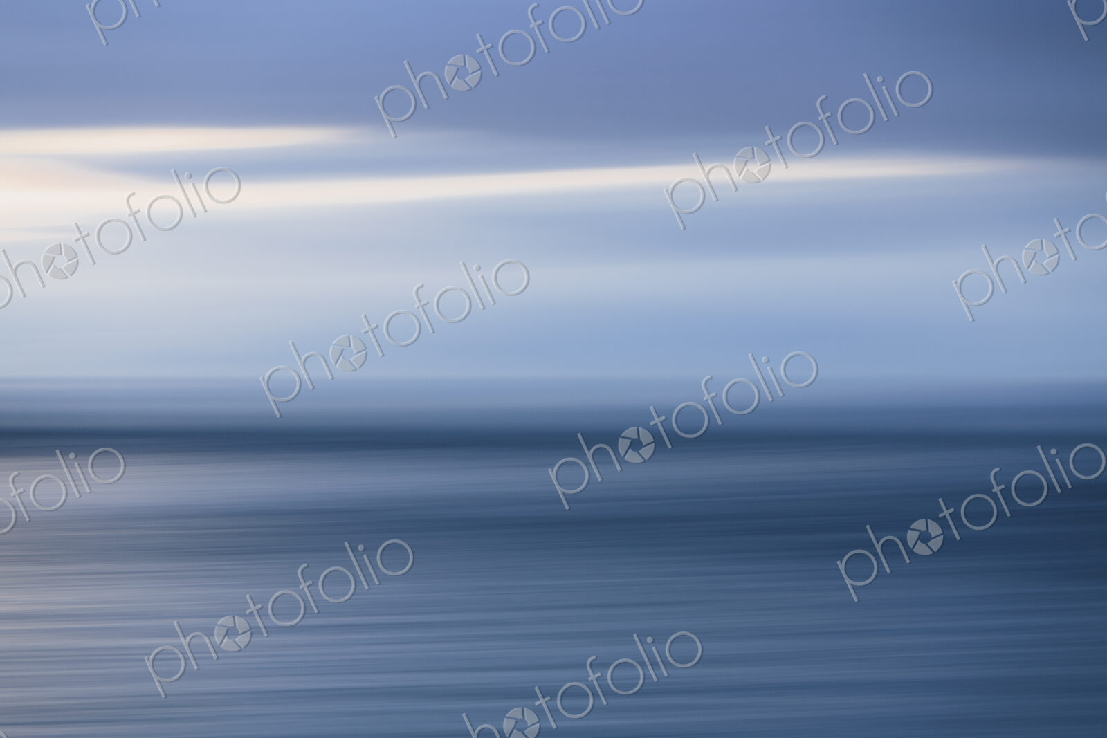 The sea and sky over Puget Sound in Washington, USA. The horizon with light cloud…
