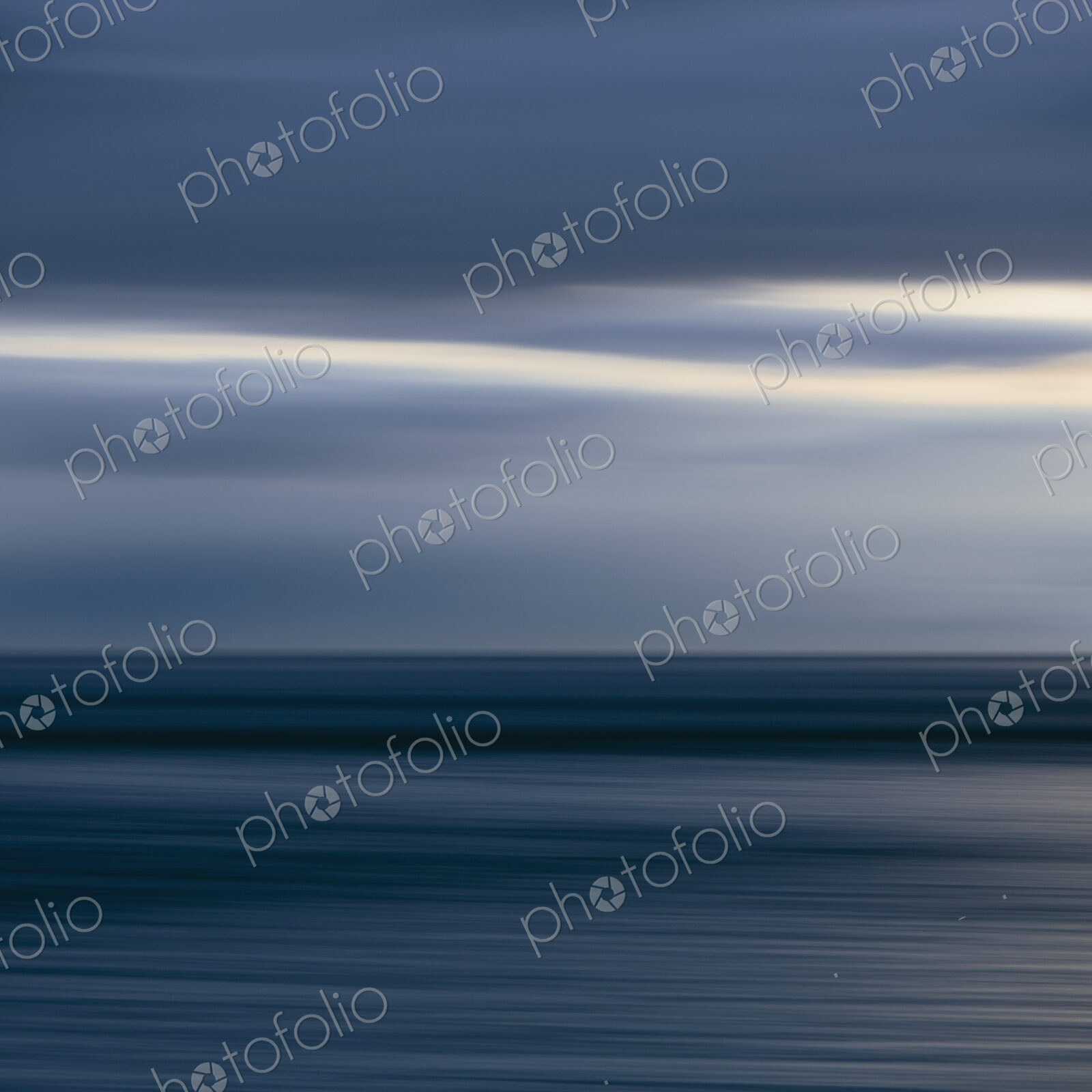 The sea and sky over Puget Sound in Washington, USA. The horizon with light cloud…