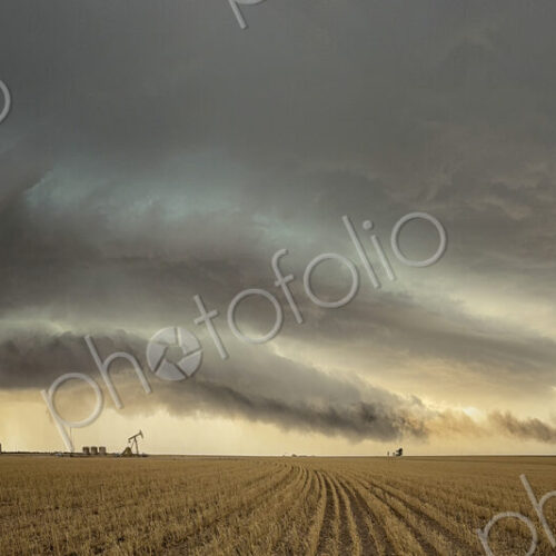 The skies full of clouds, above cornfields, a Severe-Warned Supercell storm.