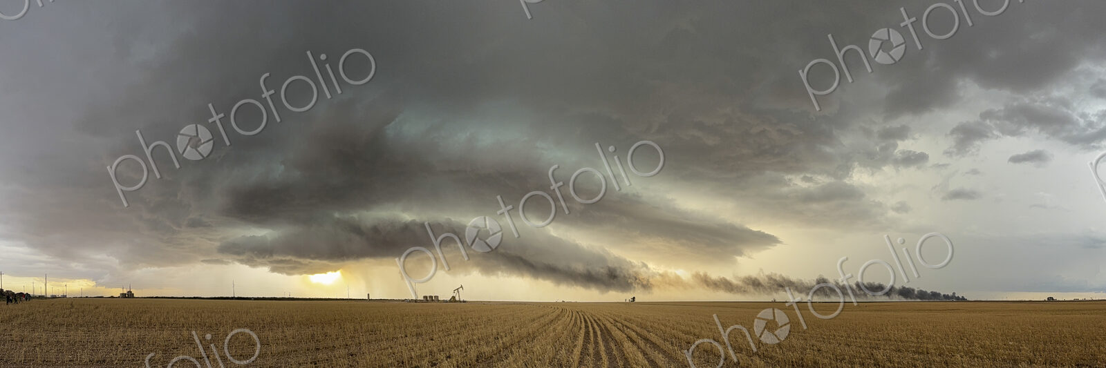 The skies full of clouds, above cornfields, a Severe-Warned Supercell storm.