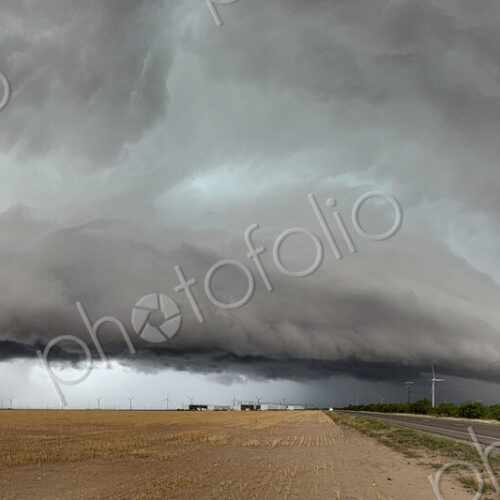 The skies full of clouds, above cornfields, a Severe-Warned Supercell storm.