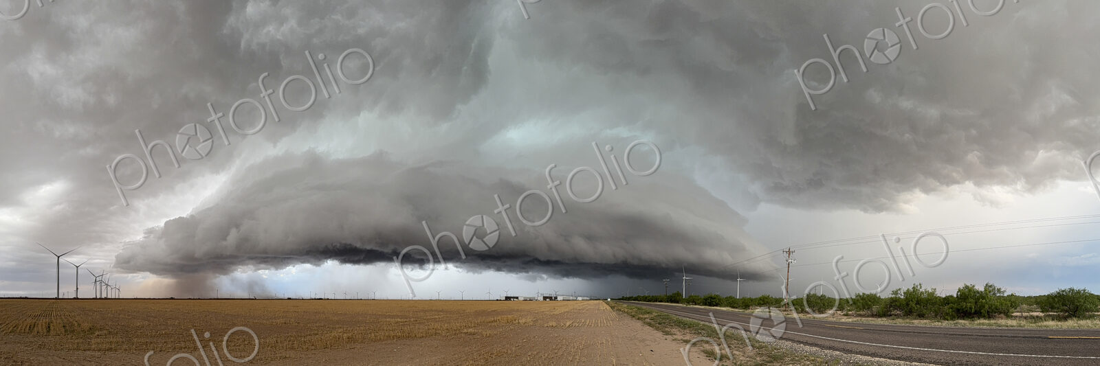 The skies full of clouds, above cornfields, a Severe-Warned Supercell storm.