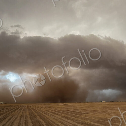 The skies full of clouds, above cornfields, a Severe-Warned Supercell storm.