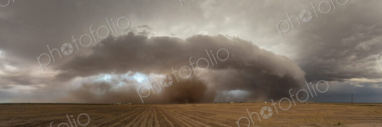 The skies full of clouds, above cornfields, a Severe-Warned Supercell storm.