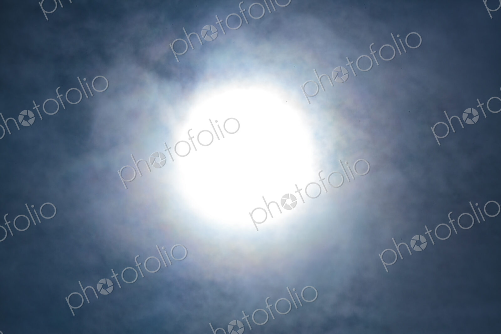 The sun, blurred and behind clouds, USA
