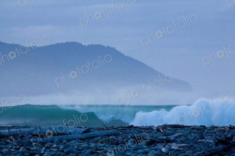 The surf breaking on shore on a beach at the mouth of the River Elwha on Olympic…