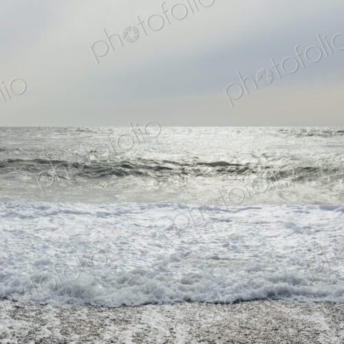 The surface of the ocean and waves, moody overcast sky above The surface of the ocean and waves, moody overcast sky above