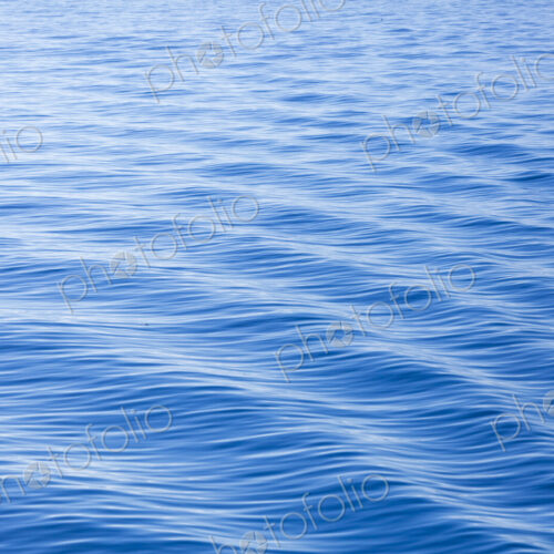 The surface of the ocean, blue water, ripples.