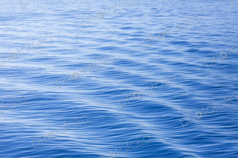 The surface of the ocean, blue water, ripples.
