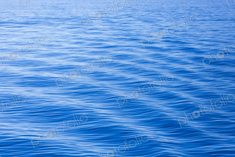 The surface of the ocean, blue water, ripples.