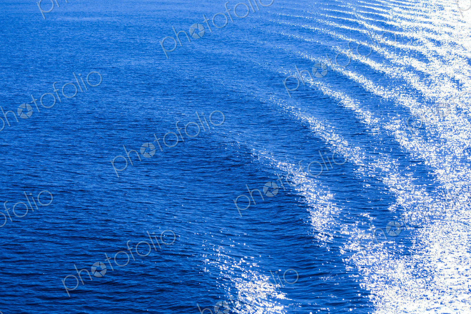 The surface of the ocean, blue water, ripples.