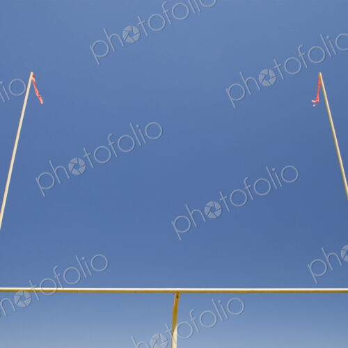 The upright shilouette of the scoring area of Football field goal posts,on a sports field