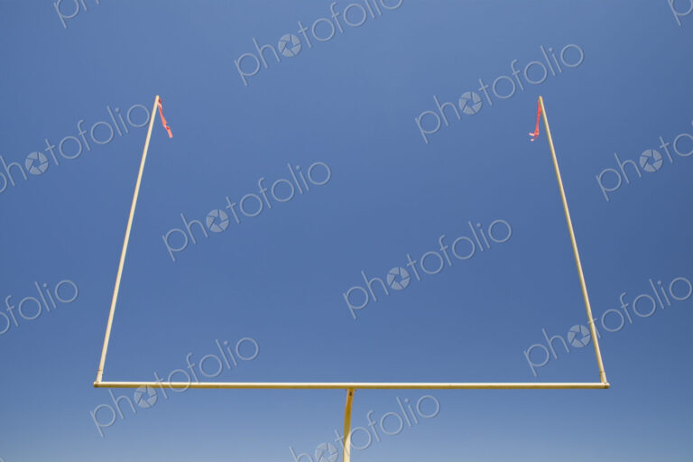 The upright shilouette of the scoring area of Football field goal posts,on a sports field