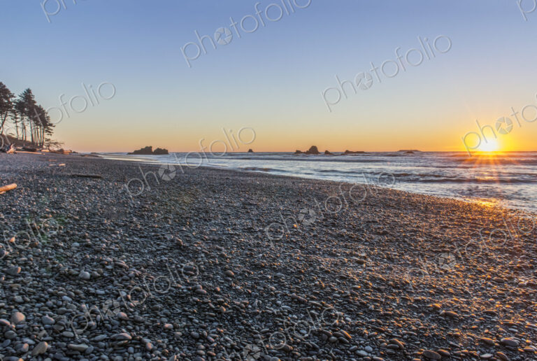 The view from Ruby Beach over the sea at sunset and sea stacks in the distance at…