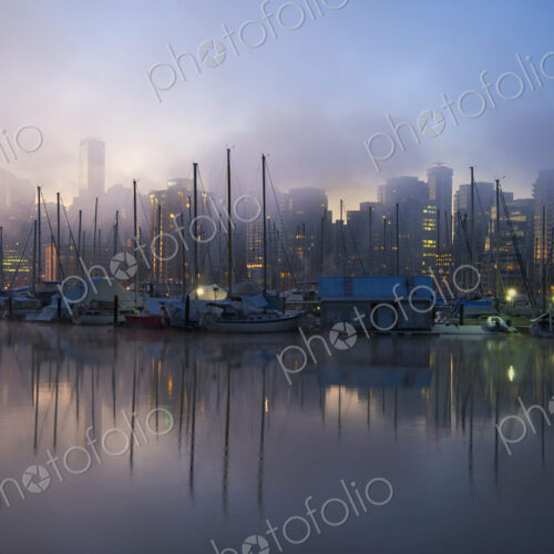 The view from Stanley Park in the early morning with mist rising from the water,… The view from Stanley Park in the early morning with mist rising from the water,…