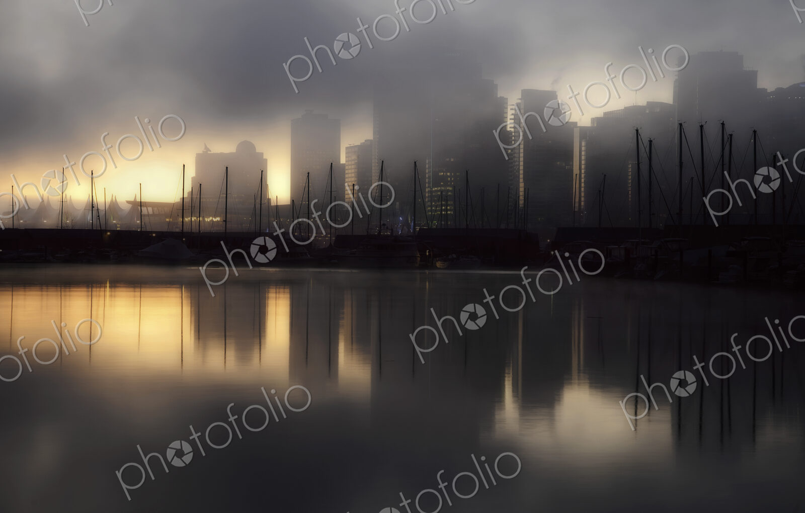 The view from Stanley Park in the early morning with mist rising from the water,…