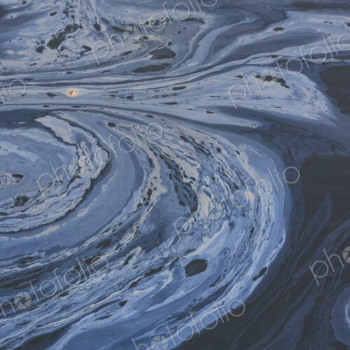 The view from above of a layer of oil, a slick on the waters of Puget Sound. The view from above of a layer of oil, a slick on the waters of Puget Sound.