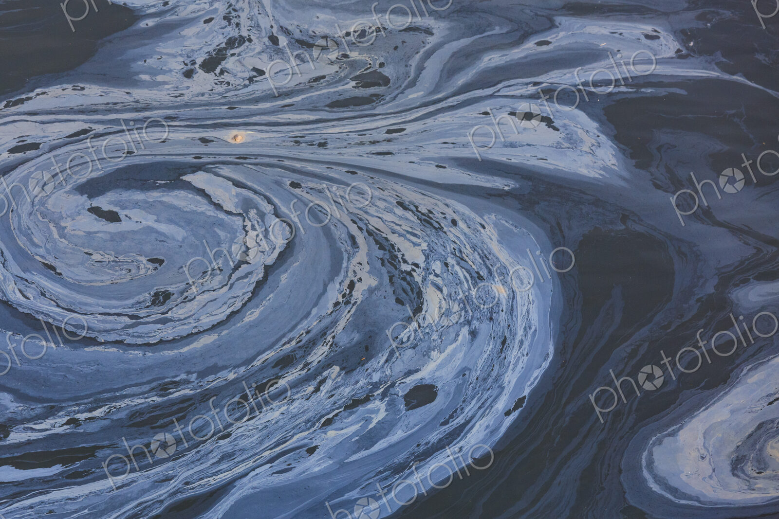 The view from above of a layer of oil, a slick on the waters of Puget Sound.