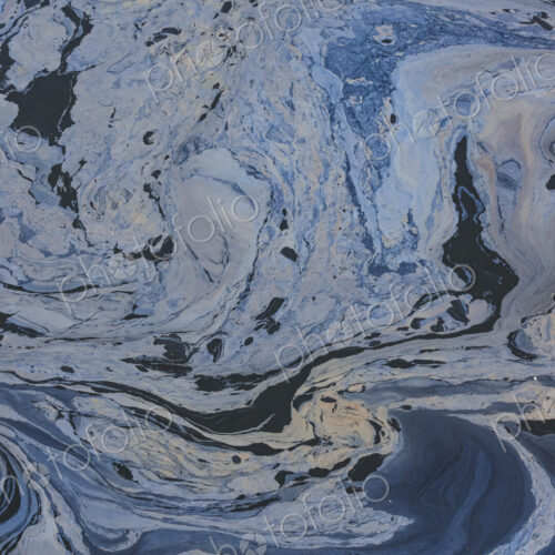 The view from above of a layer of oil, a slick on the waters of Puget Sound. The view from above of a layer of oil, a slick on the waters of Puget Sound.