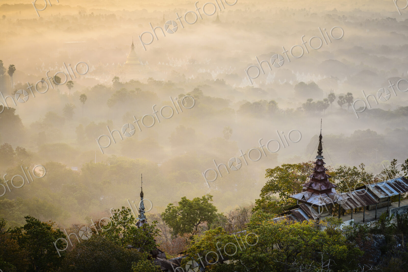 The view over the plain of temples, stupas rising from the mist, lakes and woodland.
