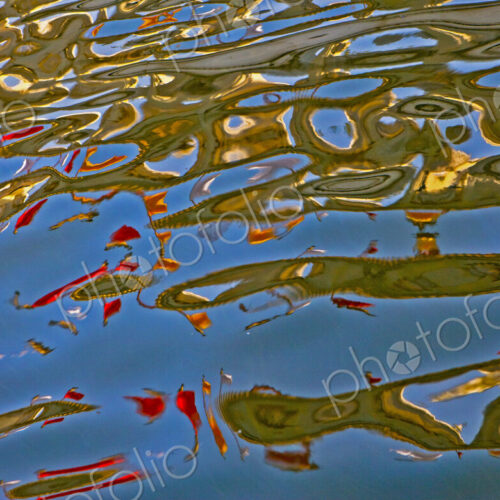 The water surface of a lake, calm waters and colourful patterns The water surface of a lake, calm waters and colourful patterns