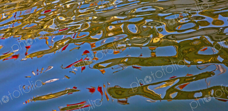 The water surface of a lake, calm waters and colourful patterns