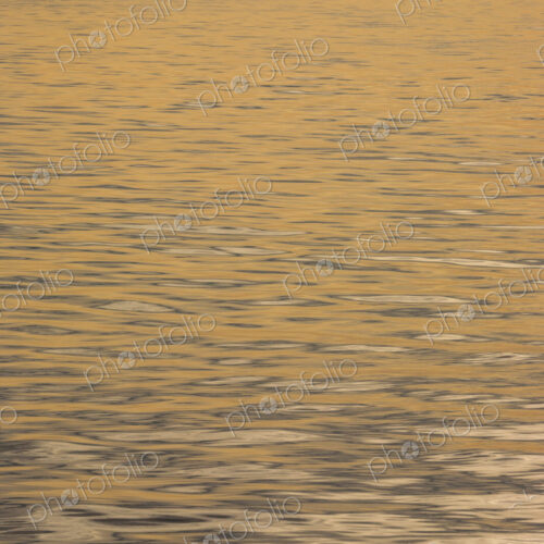 The water surface, ripples and reflections and shadows at dusk. The water surface, ripples and reflections and shadows at dusk.
