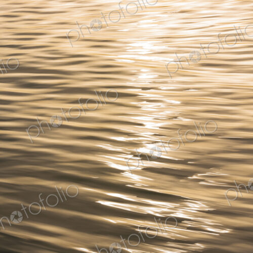 The water surface, ripples and reflections and shadows at dusk. The water surface, ripples and reflections and shadows at dusk.