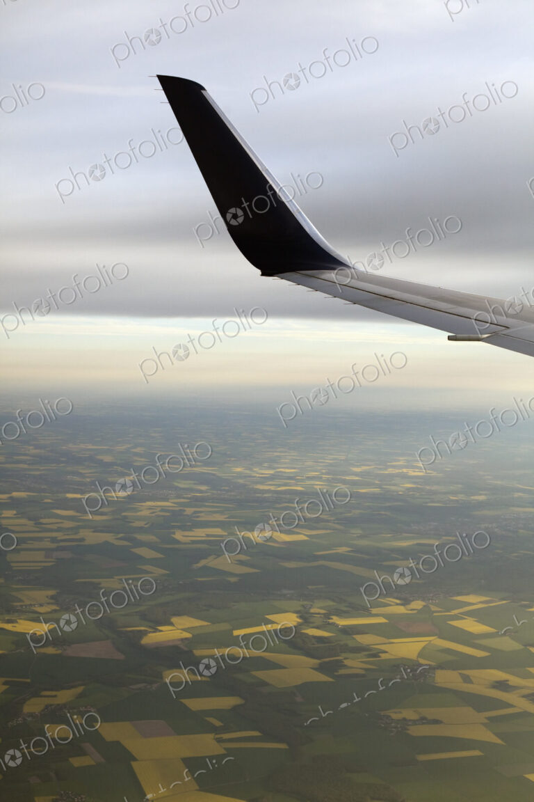 The winglet or wing tip of an aircraft viewed from the passenger window.