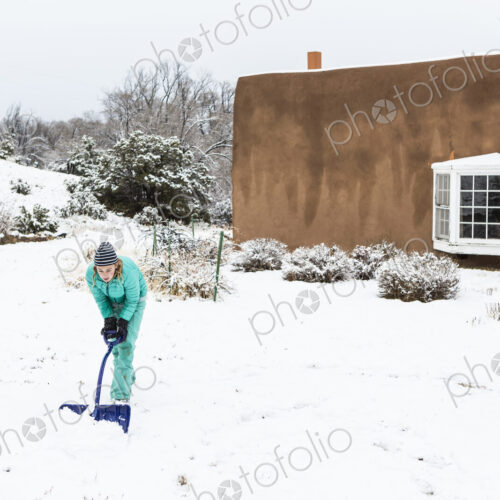 Thirteen year old teenage girl building a snowman Thirteen year old teenage girl building a snowman