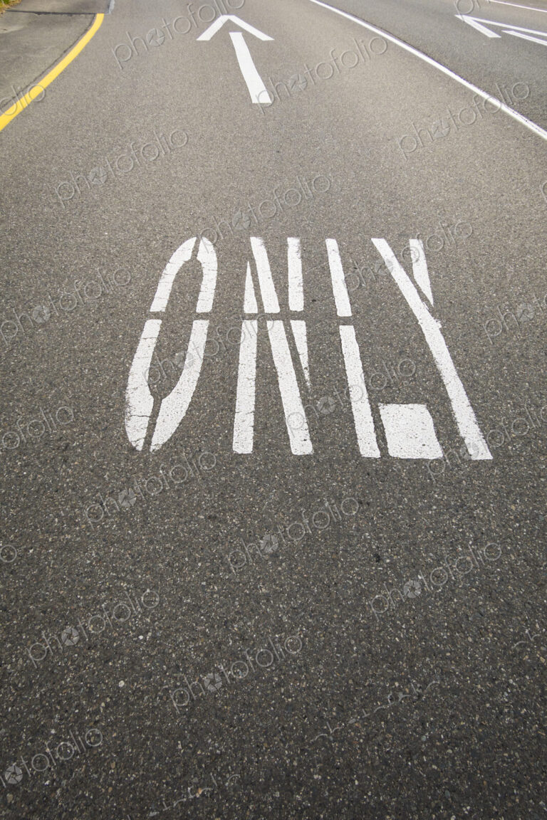 This way only road, Ahead Only with arrow symbols painted on the road surface.