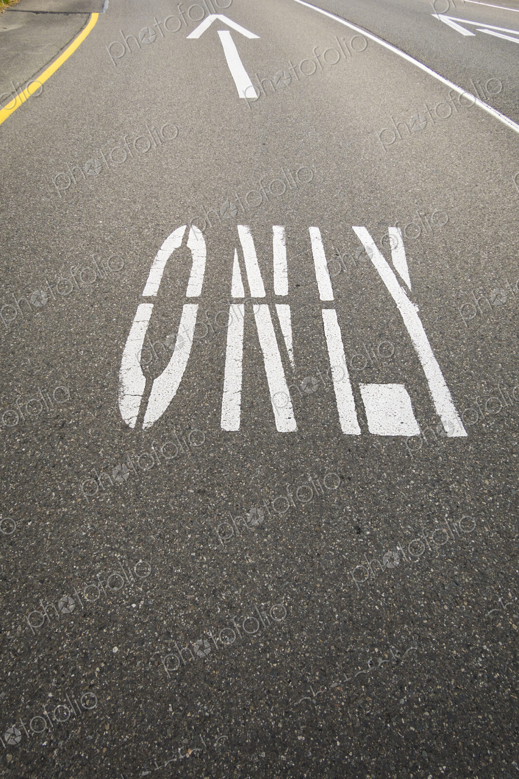This way only road, Ahead Only with arrow symbols painted on the road surface.