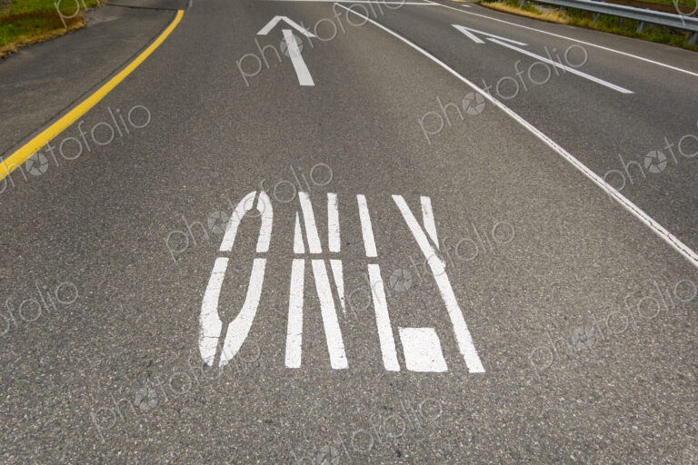 This way only road, Ahead Only with arrow symbols painted on the road surface.