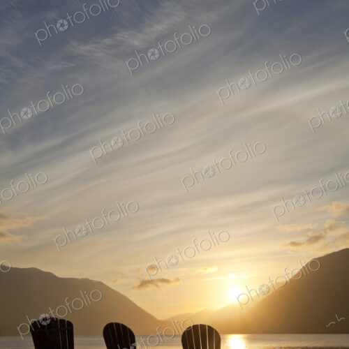 Three Adirondack style wooden lounge chairs at Crescent Lake Lodge at Olympic National… Three Adirondack style wooden lounge chairs at Crescent Lake Lodge at Olympic National…
