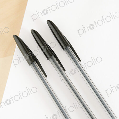 Three ball point pens lined up in a row on a white background. Three ball point pens lined up in a row on a white background.