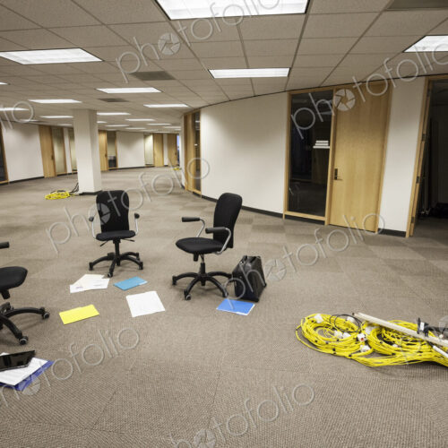 Three chairs sitting alone in an open area in an unoccupied office space.
