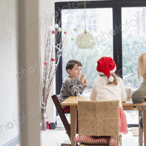Three children at a table at Christmas