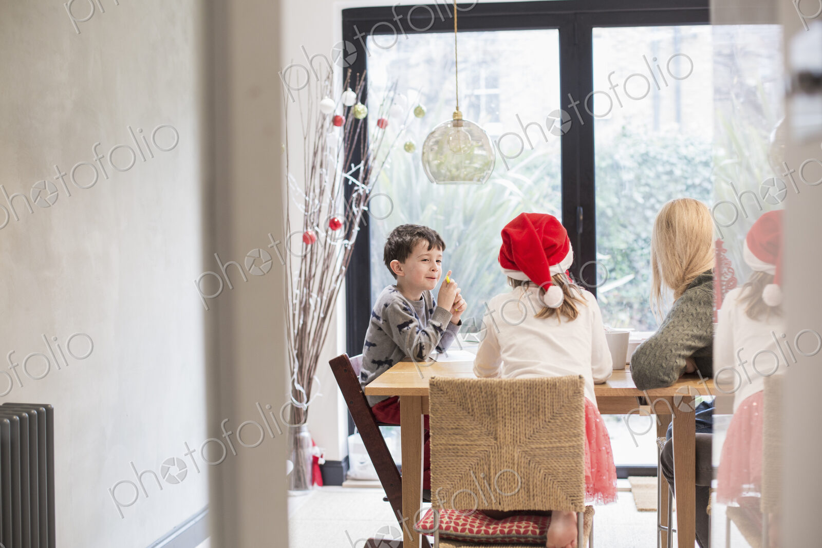 Three children at a table at Christmas