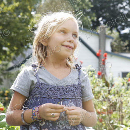Three children in a garden, picking vegetables. Three children in a garden, picking vegetables.